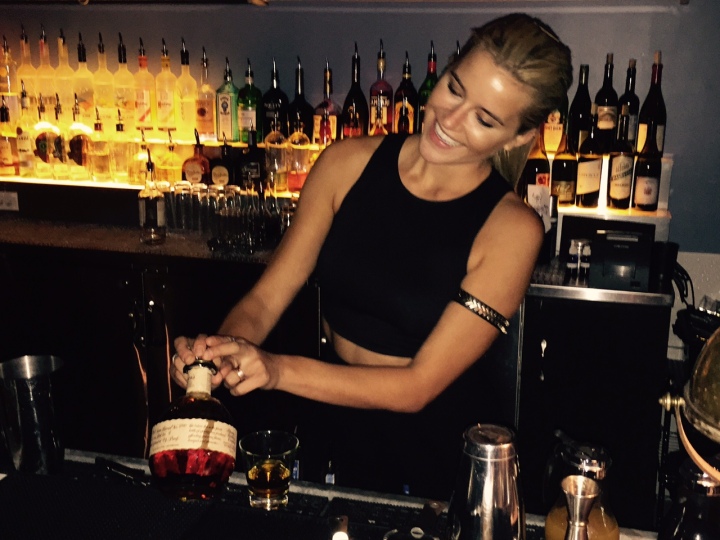 Behind the bar, Kate Havness pours her favorite whisky, Blanton's (photo by Scott Bridges) 